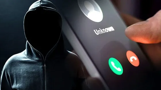 Fraud Phone Numbers Man with hoodie picture near a phone with unknown caller